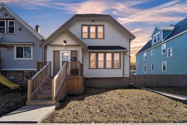 view of front of home featuring fence