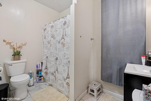 bathroom with marble finish floor, toilet, vanity, and baseboards