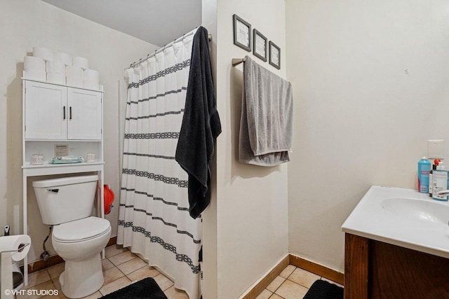 full bathroom with toilet, curtained shower, tile patterned flooring, baseboards, and vanity