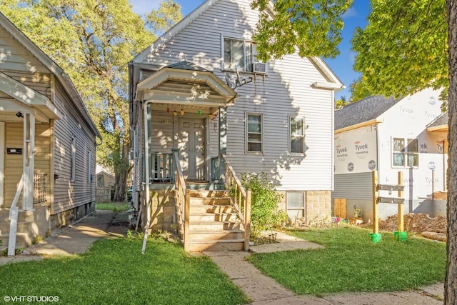 back of property with a lawn