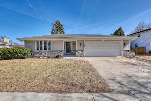 ranch-style home featuring a front yard, an attached garage, fence, and driveway