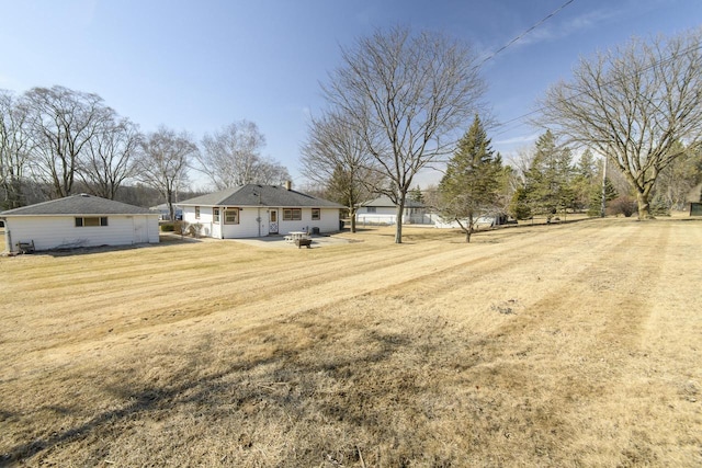 view of yard with a fire pit