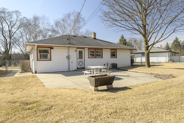 rear view of property with a yard, a patio, central air condition unit, and a gate