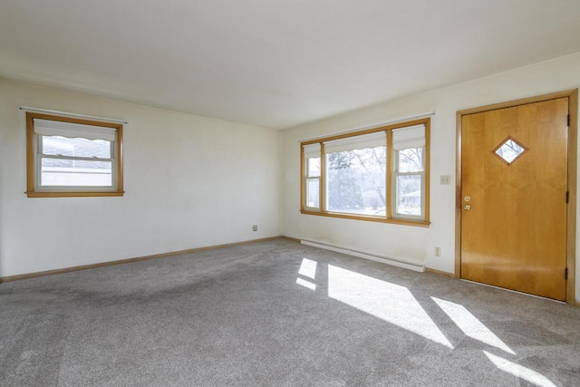 carpeted foyer entrance with baseboard heating and baseboards