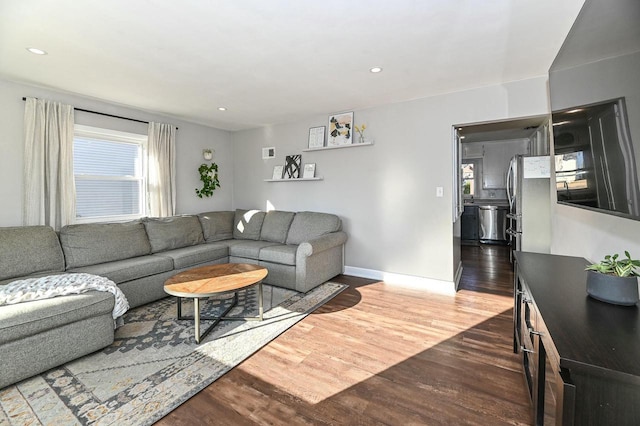 living room featuring recessed lighting, wood finished floors, and baseboards