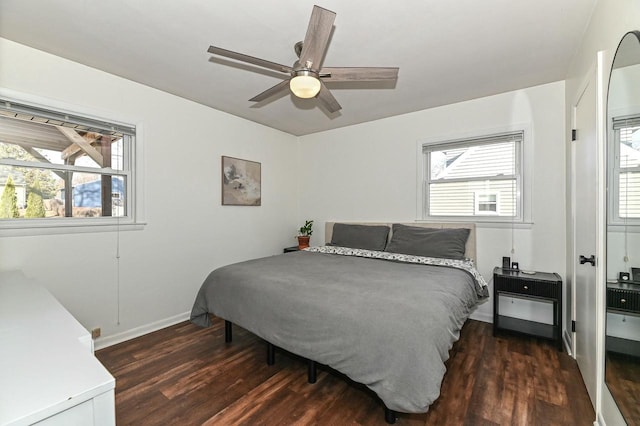 bedroom with a ceiling fan, baseboards, and wood finished floors