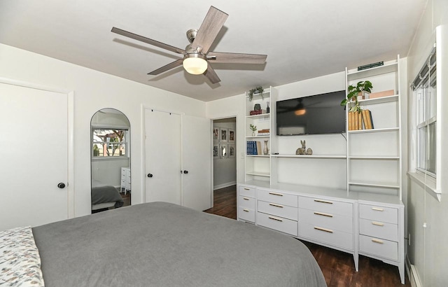 bedroom with dark wood finished floors and a ceiling fan