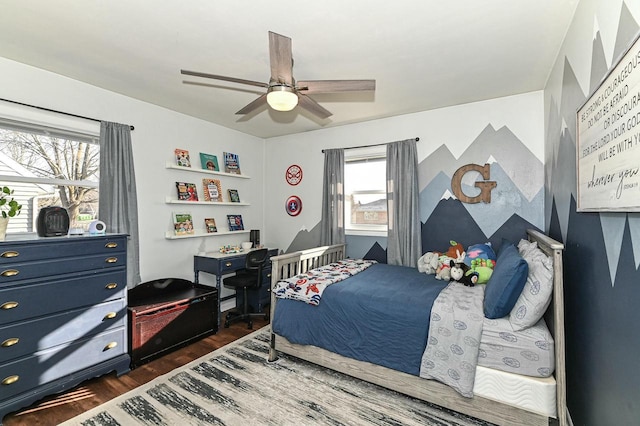 bedroom featuring a ceiling fan and dark wood-style flooring