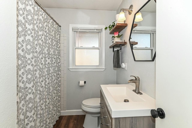 bathroom featuring curtained shower, toilet, baseboards, and wood finished floors