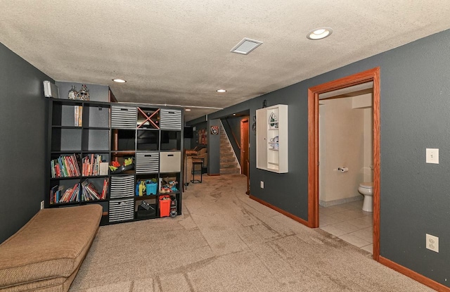 interior space featuring visible vents, a textured ceiling, stairway, carpet, and baseboards