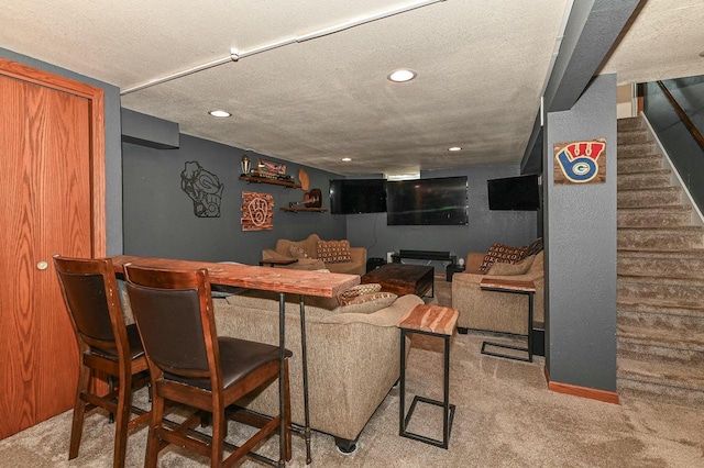 living area with stairway, carpet, and a textured ceiling