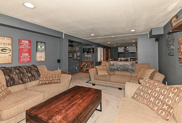 carpeted living room featuring recessed lighting and a textured ceiling