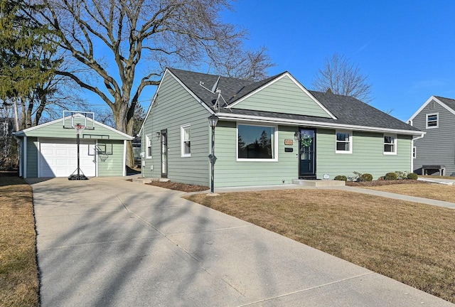 ranch-style house with a shingled roof, a detached garage, a front lawn, an outdoor structure, and driveway