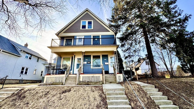 view of front facade featuring a balcony and covered porch