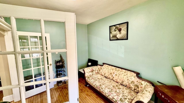 sitting room with wood-type flooring