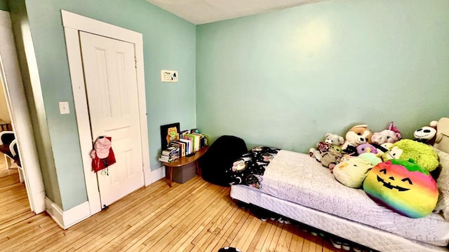 bedroom featuring baseboards and wood-type flooring