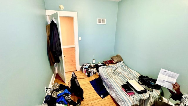 bedroom featuring visible vents and wood-type flooring