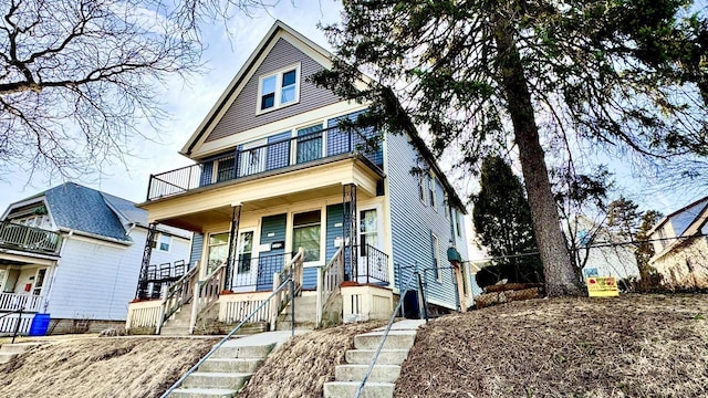 view of front of home featuring a balcony and covered porch