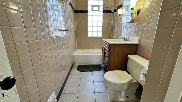 bathroom featuring vanity, visible vents, tile walls, toilet, and tile patterned floors