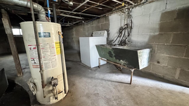 unfinished basement with gas water heater, washer / clothes dryer, and a sink