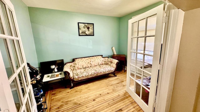 sitting room featuring french doors and wood-type flooring