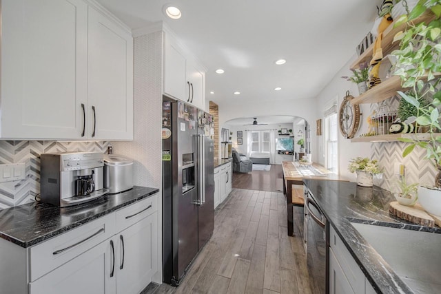 kitchen featuring arched walkways, high end refrigerator, white cabinetry, and open shelves