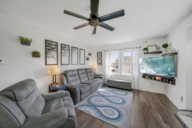 living area with wood finished floors, baseboards, and ceiling fan