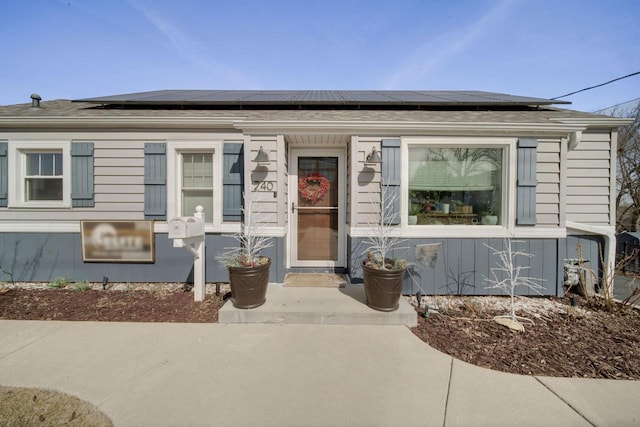 bungalow featuring roof mounted solar panels