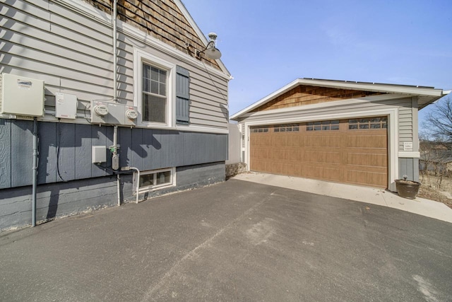 view of side of home with an outdoor structure and a garage