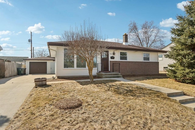 ranch-style house with fence, a chimney, concrete driveway, a detached garage, and brick siding