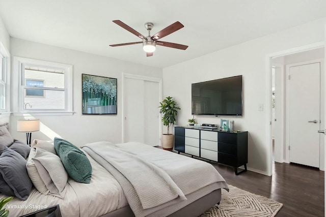 bedroom featuring a closet, baseboards, ceiling fan, and dark wood-style flooring