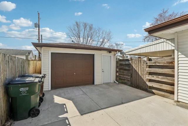 detached garage with driveway and fence