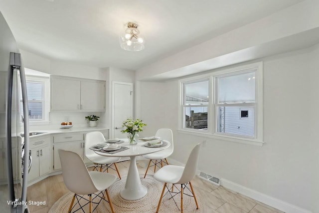 dining room featuring visible vents and baseboards