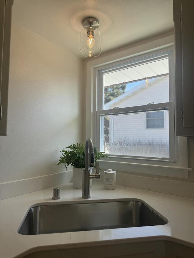 details featuring light countertops and a sink