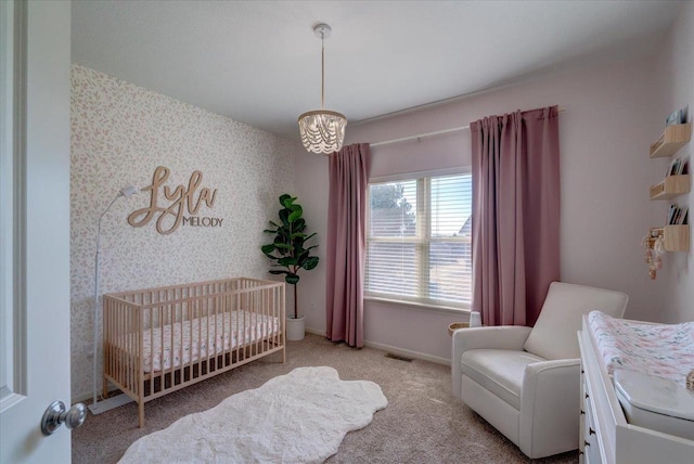 bedroom featuring baseboards, visible vents, wallpapered walls, an accent wall, and carpet flooring