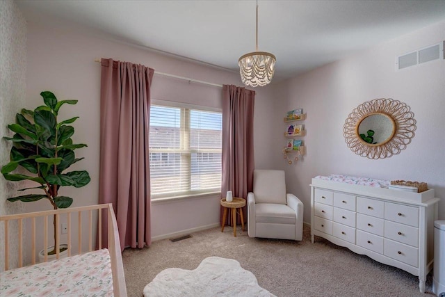 carpeted bedroom featuring a notable chandelier, visible vents, and baseboards