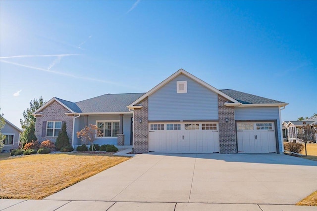 view of front of property with a front lawn, driveway, a shingled roof, a garage, and brick siding