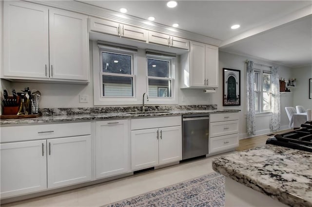 kitchen featuring a sink, stainless steel dishwasher, white cabinetry, recessed lighting, and light stone countertops