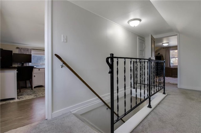 stairway with baseboards, carpet, and lofted ceiling