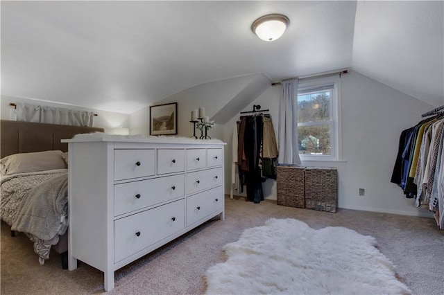 bedroom with vaulted ceiling and light carpet