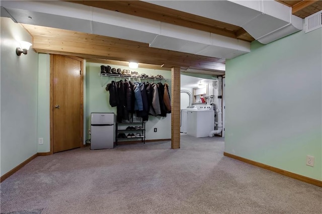 unfurnished bedroom with visible vents, washer / dryer, carpet flooring, and freestanding refrigerator