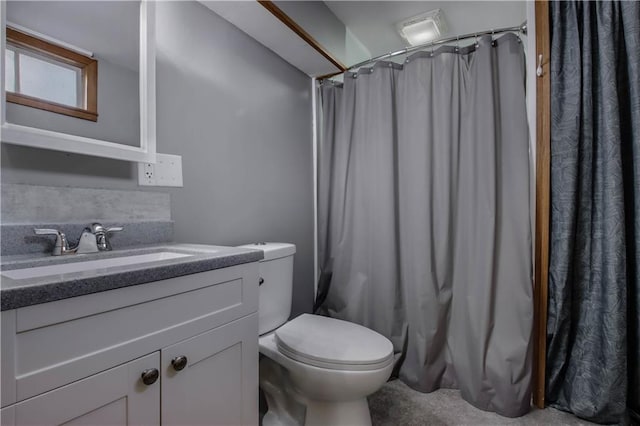 bathroom featuring toilet, vanity, and a shower with shower curtain