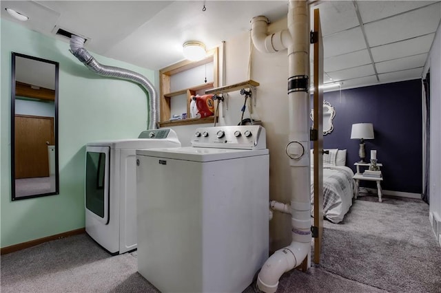 clothes washing area with washer and dryer, laundry area, carpet, and baseboards