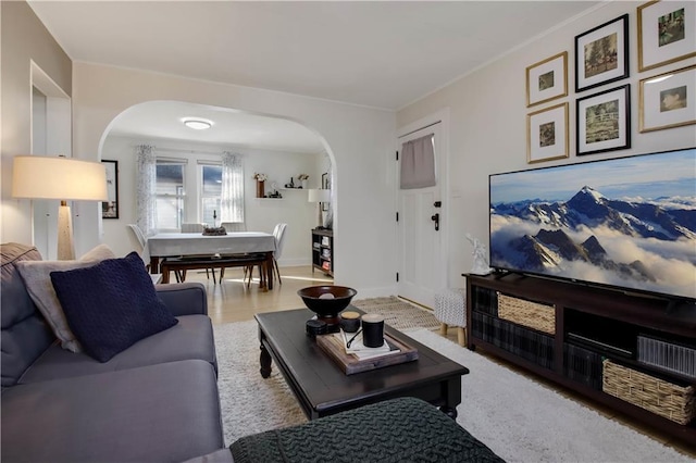 living room with baseboards and arched walkways