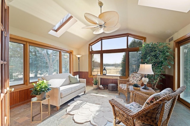 sunroom with visible vents, lofted ceiling with skylight, and a ceiling fan