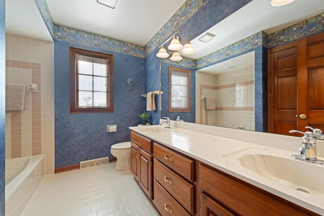 full bathroom with wallpapered walls, toilet, visible vents, and a sink