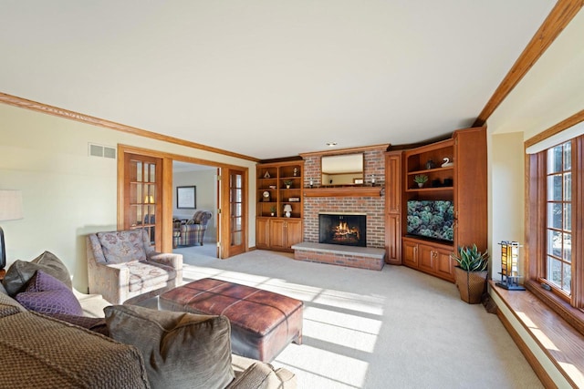 living area with visible vents, french doors, light carpet, crown molding, and a brick fireplace