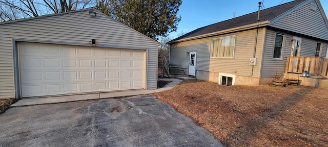 view of side of home with an outbuilding and a detached garage