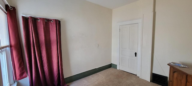 unfurnished bedroom featuring visible vents, baseboards, and carpet flooring