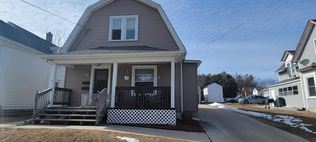 dutch colonial with covered porch and a gambrel roof